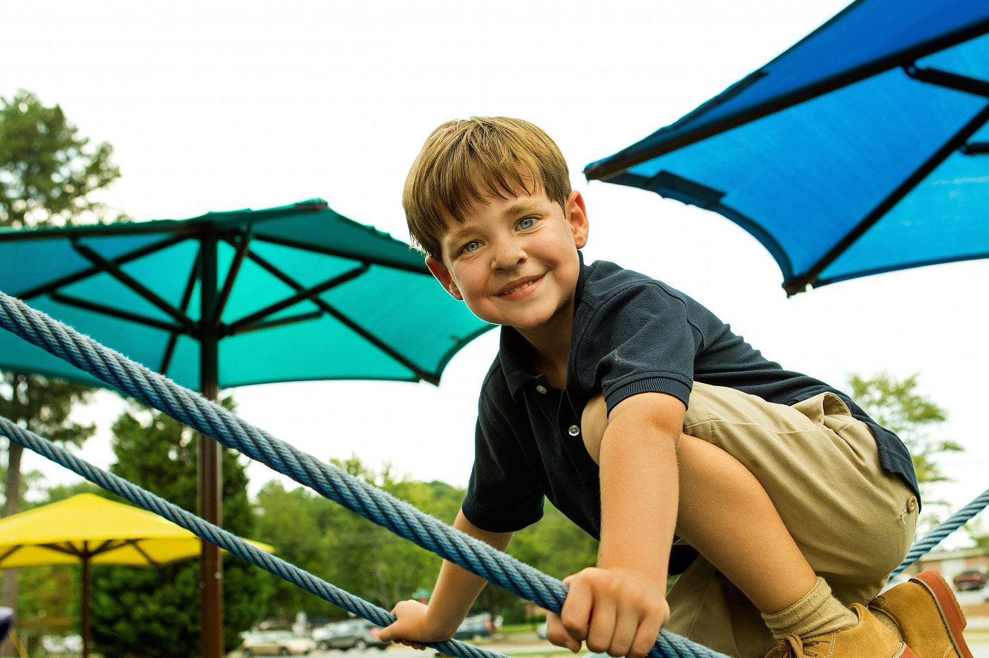 Child Climbing on Playground with Playground Shades